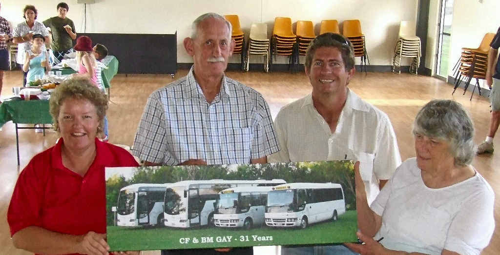 Tracy and Matt Heslin, current owners of what is now the Allora School Bus and Local Charter, present a gift to Col and Bette Gay on their retirement, celebrated last Friday at the Allora State School.